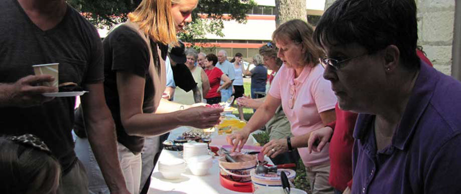 People being served at ice cream social